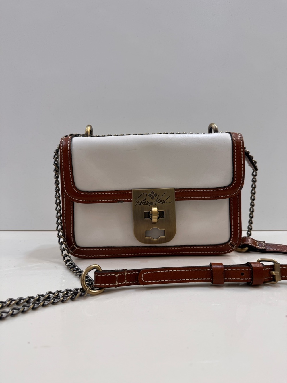 Patricia Nash White and Brown Trim Leather Crossbody with Antique Brass Lock